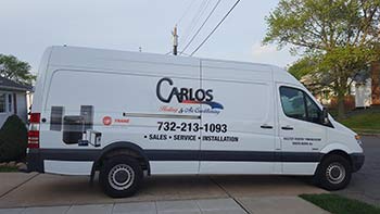 Carlos Heating and Air Conditioning work van